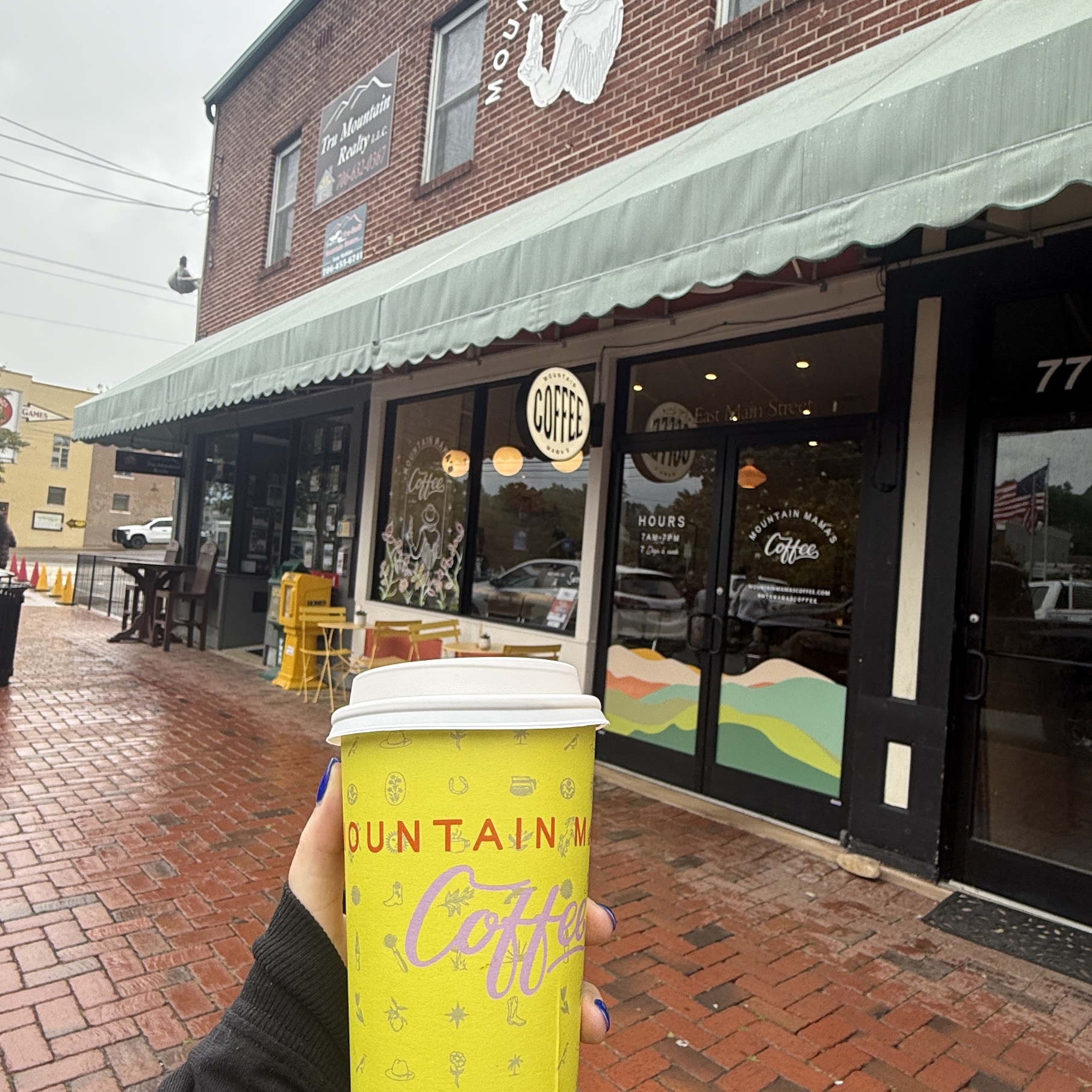 Photo in Downtown Blue Ridge Holding a Coffee Cup highlighting the allure of moving to Blue Ridge